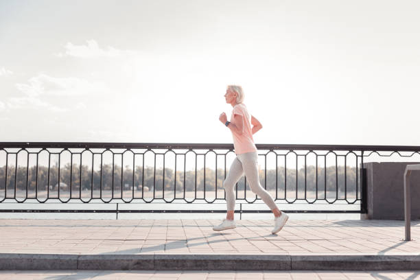 istock Concentrated aged woman running and spending time on fresh air 936894130