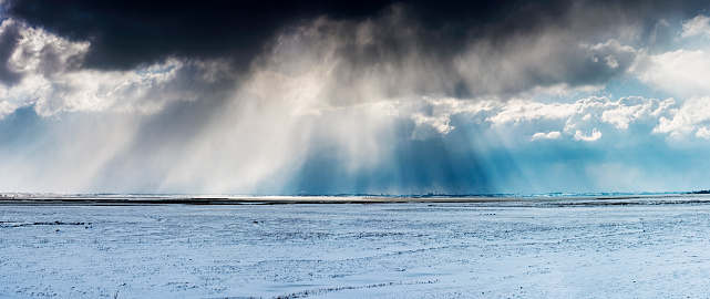 Dramatic snowstorm captured over Nyord Enge looking towards the town of Stege in the distance. Panorma made up of 4 images. Colour horizontal with lots of copy space. Photographed in the winter of 2018.