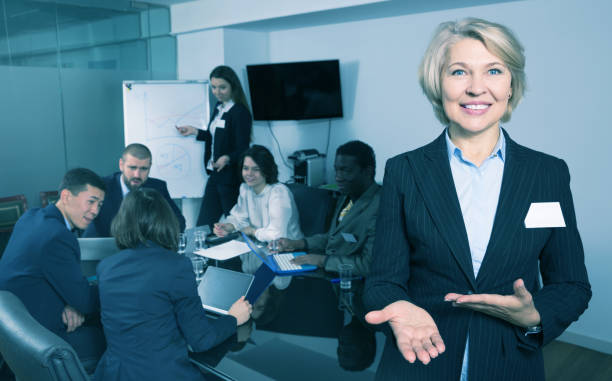 istock Woman with team in boardroom 936898546