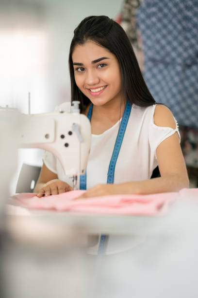 istock Happy seamstress sewing at an atelier 936901554