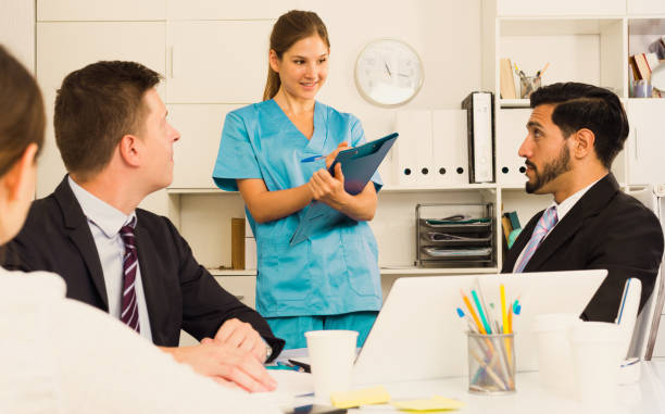 istock Medical worker telling office staff about first aid 936902436