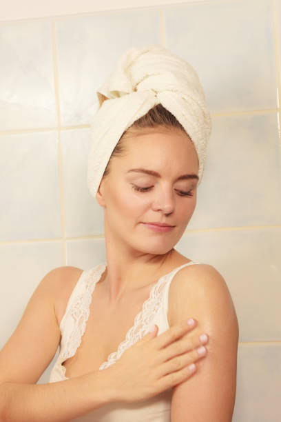 istock Woman applying moisturizer cream on her body 936903154
