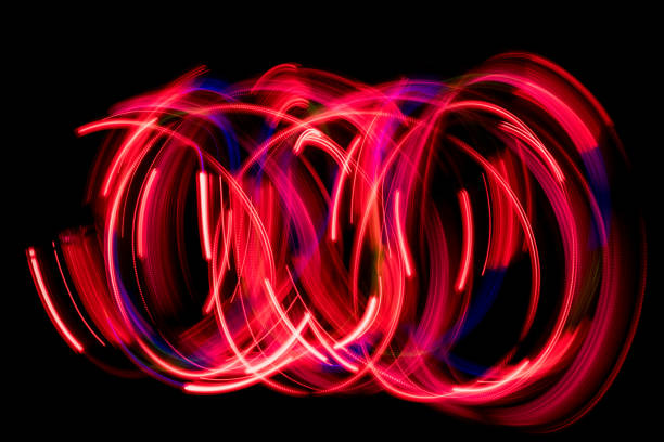 istock Red color abstract light painting. LED lights on black background 936907852