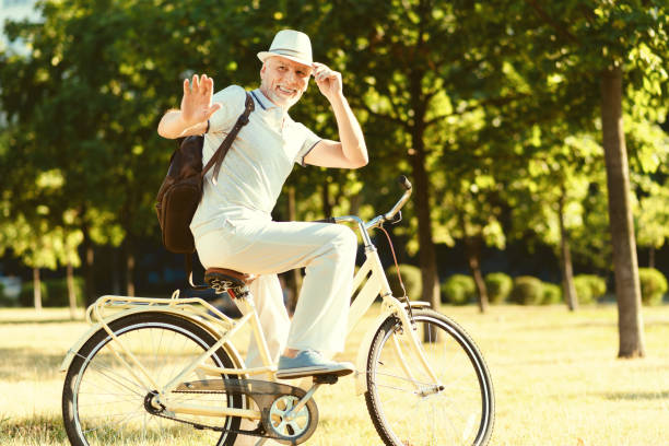 istock Nice delighted man riding a bike 936907866