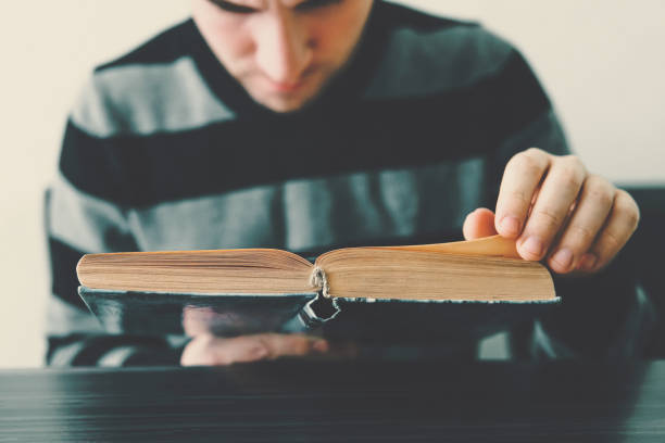 istock An adult man reading a Book 936908752