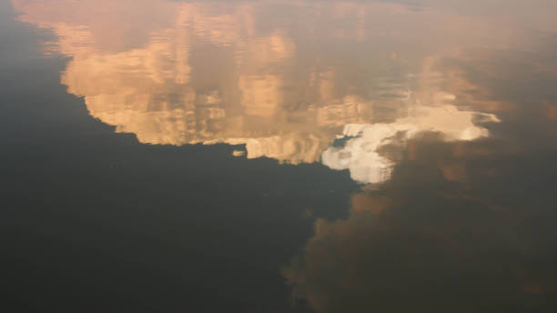 Sunset sky reflect on water surface stock photo