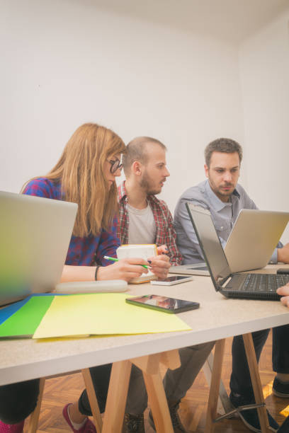 istock Real and ordinary young people in the office being creative and resolving bussines plans. 936921516