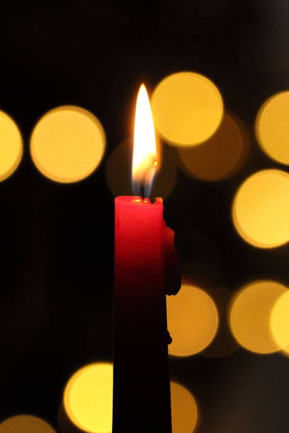 istock Christmas candle with bokeh lights 936923978