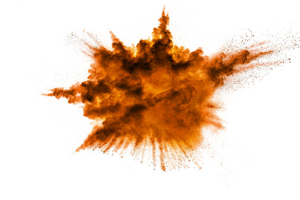 istock abstract orange dust explosion on white background. abstract orange powder splattered on white background, Freeze motion of orange powder splash. 936938164
