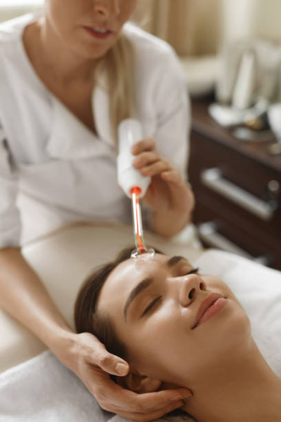 istock Face Beauty Treatment. Woman Using Darsonval Skin Care Device 936952812