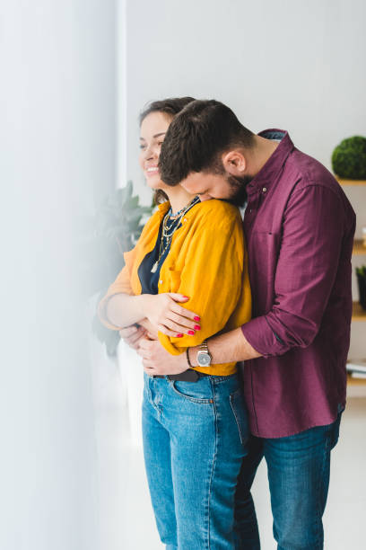 istock Woman smiling with her boyfriend on her shoulder 936956444