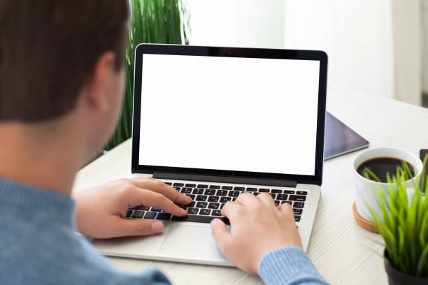 istock man sitting with laptop computer isolated screen at desk room 936956970