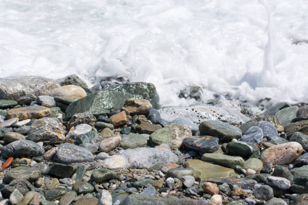 istock Wet pebble stones on the beach close up 936956976