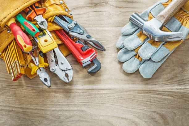 istock Construction tooling tool belt protective gloves on wooden board 936957102