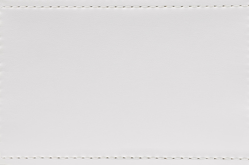 Seam and white leather texture background. Blank material made from animal skin for furniture.