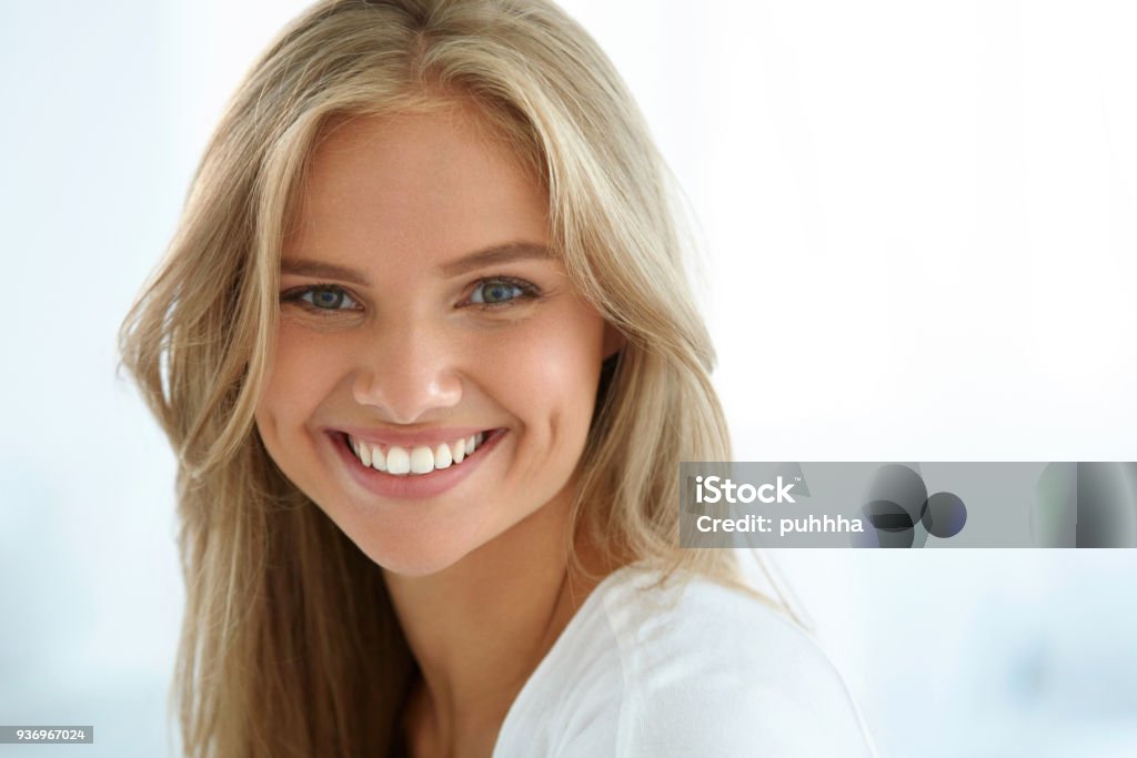 Beauty Woman Portrait. Girl With Beautiful Face Smiling Beauty Woman Portrait. Closeup Of Beautiful Happy Girl With Perfect Smile, White Teeth Smiling At Camera. Attractive Healthy Young Female With Fresh Natural Face Makeup Indoors. High Resolution Image Smiling Stock Photo