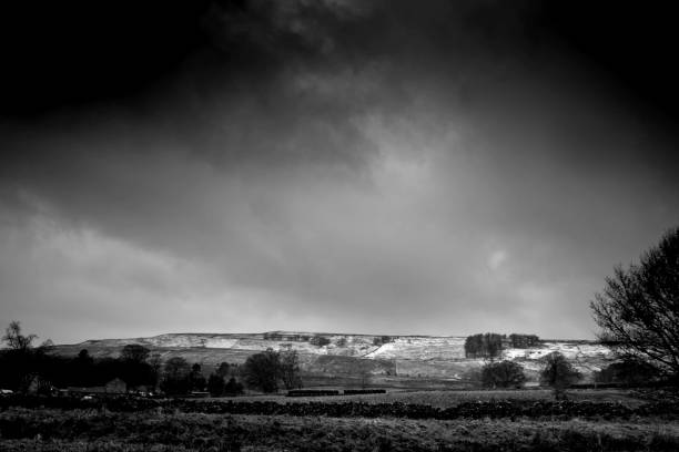 istock Dark clouds at sunset over the South Tyne. 936971890