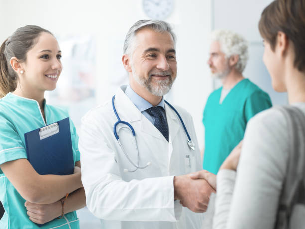 istock Confident doctor shaking patient's hand 936973572