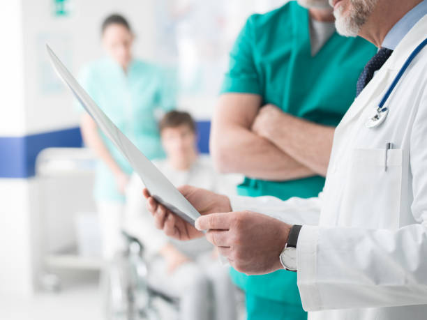 istock Professional doctors examining patient's x-ray 936982438