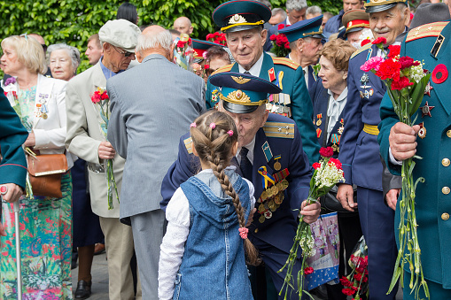 Kiev: Girl gives flowers to the veterans of the Great Patriotic War in the park of eternal glory