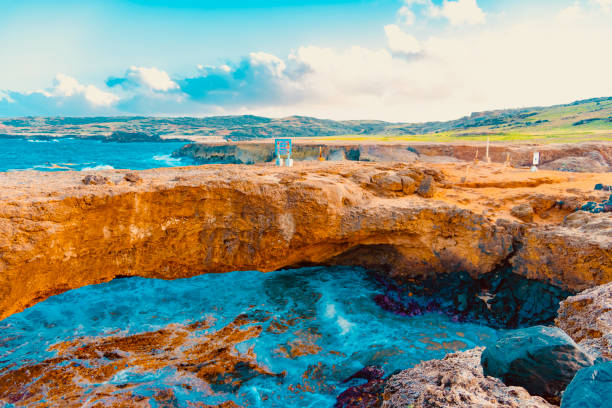 Arikok Natural Park on the island of Aruba in the Caribbean Sea with deserts and ocean waves on the rocky coast