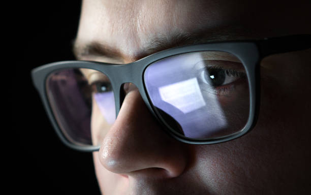 Focused and thoughtful man. Coder, programmer or developer using laptop in dark. Businessman working late. Student studying at night. Focused and thoughtful man. Coder, programmer or developer using laptop in dark. Businessman working late. Student studying at night. Close up of glasses with reflection of computer screen. eye reflection stock pictures, royalty-free photos & images