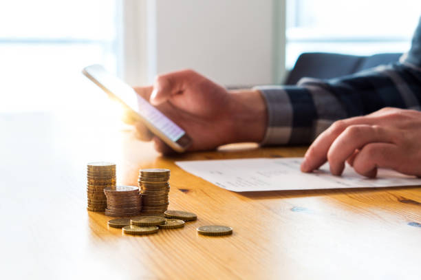 Paying electronic bill with smartphone. Digital internet payment with mobile phone. Man using cellphone and online bank.