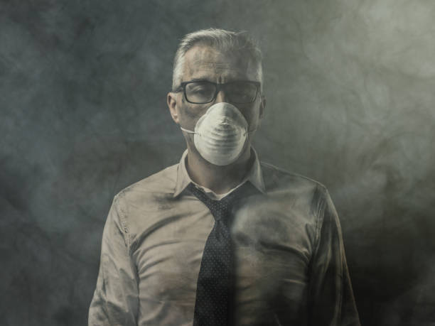 istock Businessman with mask and air pollution 936988102