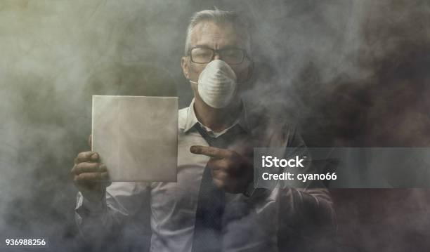 Businessman Holding A Sign And Air Pollution Stock Photo - Download Image Now - Adult, Air Pollution, Blank