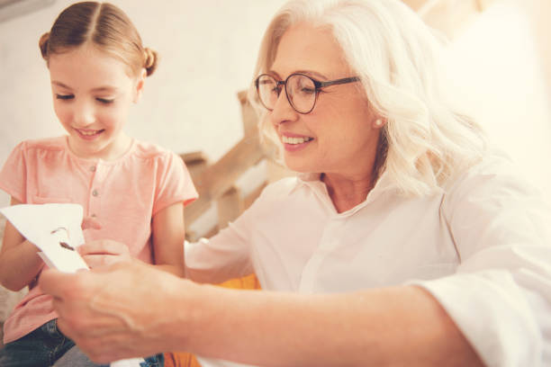 istock Happy elderly woman spending time with her granddaughter 936991462