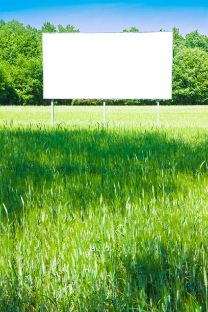 istock Blank advertising billboard in a green field - image with copy space 936991686