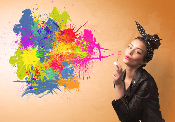istock Cute girl blowing colorful splash graffiti 936992334