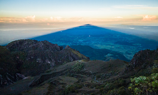 A massive triangular shadow is cast upon the landscape as the sun rises over Volcan Barú, Panama's highest point.