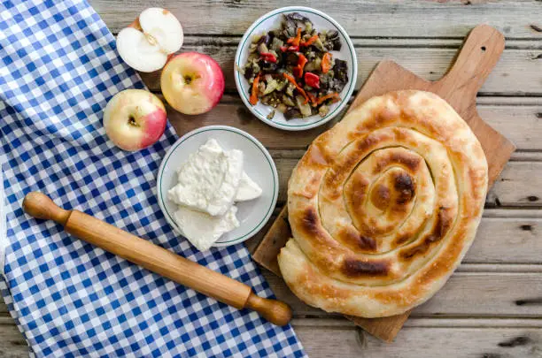 Burek with mixed fruit and cheese on wooden background