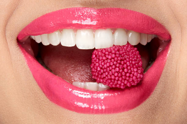 istock Pink Lips. Woman With Candy In Mouth. 937002880