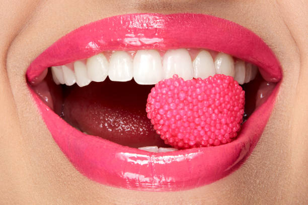 istock Pink Lips. Woman With Candy In Mouth. 937002894