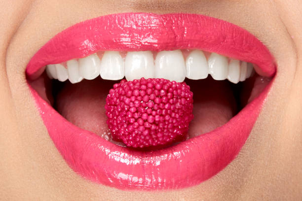 istock Pink Lips. Woman With Candy In Mouth. 937002938