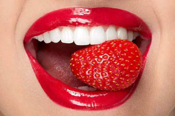 Photo of Lips. Woman With Red Lipstick And Strawberry