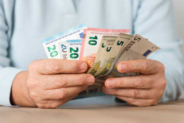 istock Senior Woman Counting Money 937009482