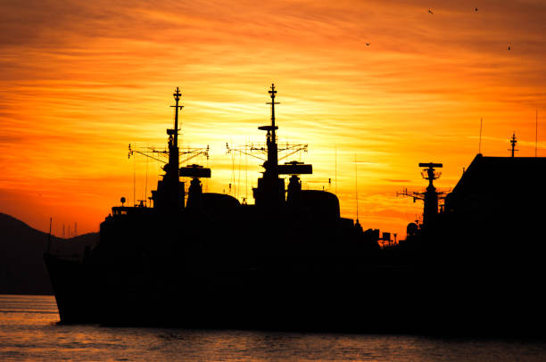 Melbourne, Australia - June 12, 2015: HMAS Melbourne (FFG 05) Adelaide-class guided-missile frigate of the Royal Australian Navy docking at Station Pier in Melbourne with the assistance of tug boats.