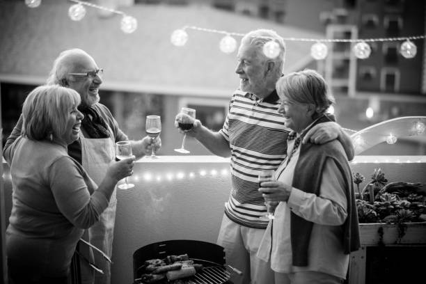 istock Senior group of people doing barbeque on the rooftop at home 937009646