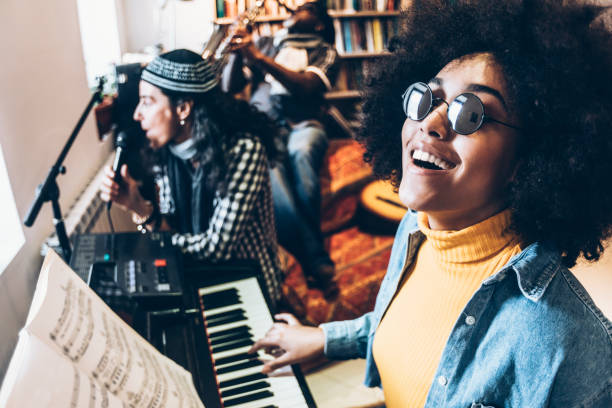 istock African woman singing and playing the piano 937013700