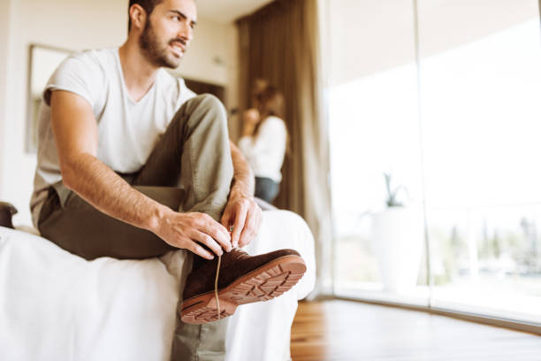 istock man dressing up in the hotel room 937014010