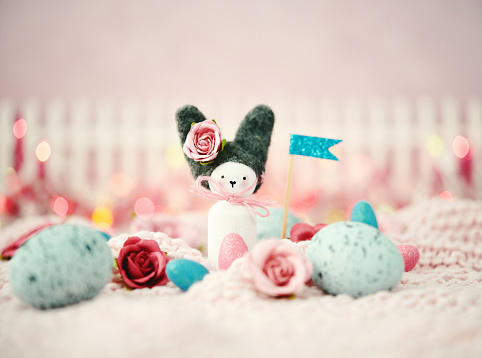 Handmade Easter bunny with holiday flags, Easter eggs and flowers \n*Bunny made by photographer