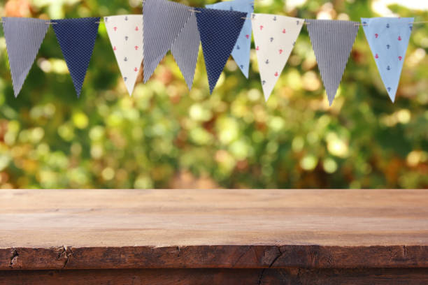 istock Empty wooden table with flags party background outdoors. for product display and presentation. 937018268