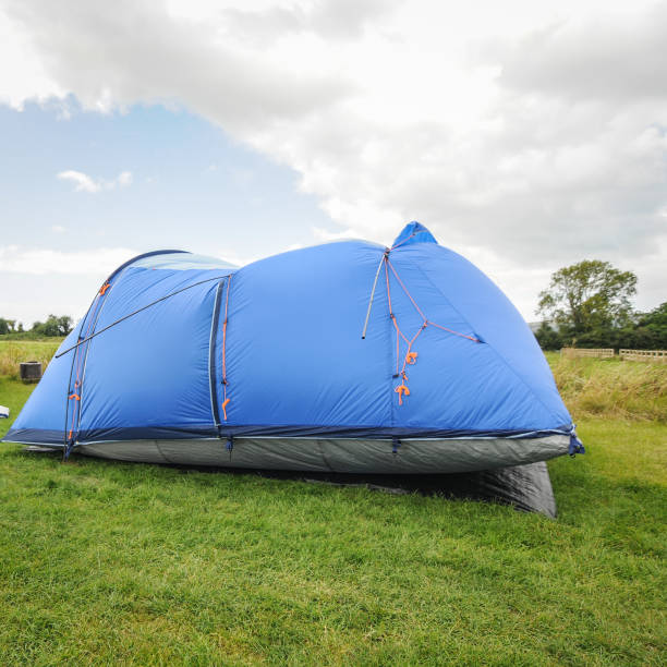 istock Setting up camping tent on a windy day at the campsite in Cheddar, Somerset, England 937018538