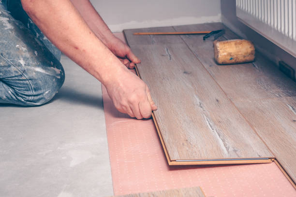 istock Working with hands installs a laminate board, professional flooring installation 937021770