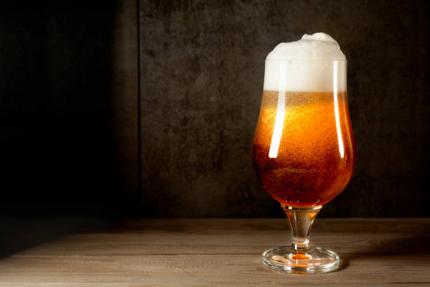 istock Ale beer cup with foam on wood 937024728