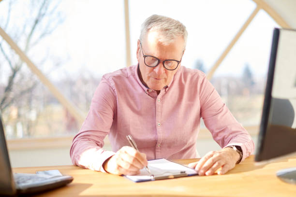 istock Senior businessman working at home. 937034238