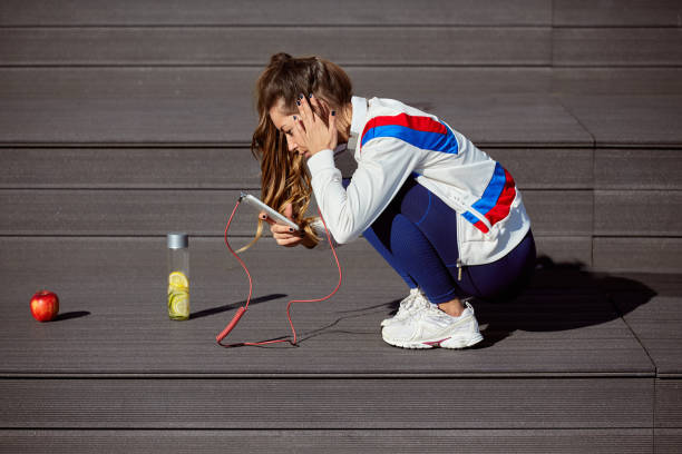 istock Girl squatting after exercises. 937034360